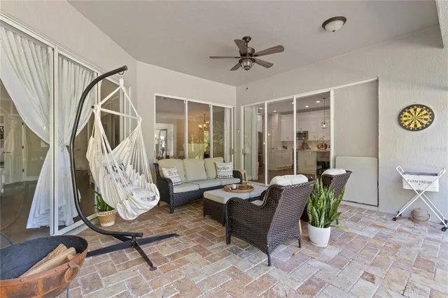 a view of the patio with couches and pool