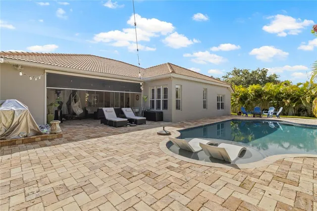 a view of a swimming pool with an outdoor space and seating area