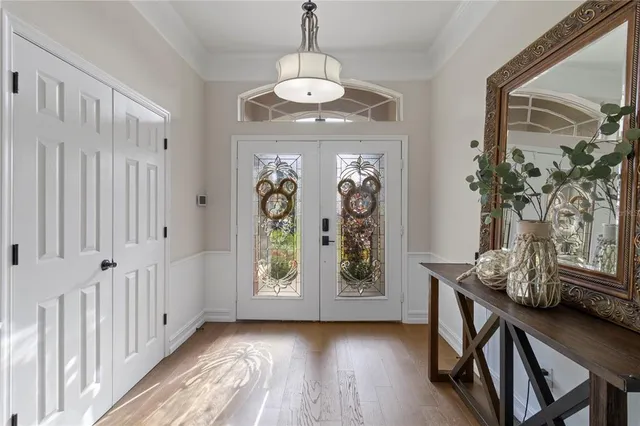 a view of a hallway with wooden floor and entryway