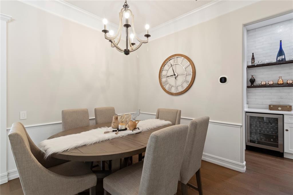 11208 Ledgement Lane Windermere, FL 34786 - Photo 9 of 36 a view of a dining room with furniture a chandelier and a wooden floor