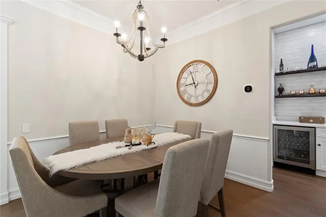 a view of a dining room with furniture a chandelier and a wooden floor