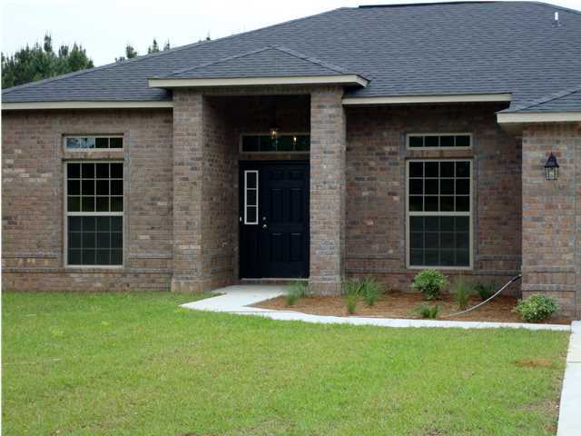 a view of a brick house with a large windows