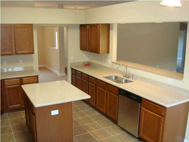 5608 Price Plantation Road Baker, FL 32531 - Photo 12 of 34 a kitchen with a sink and cabinets