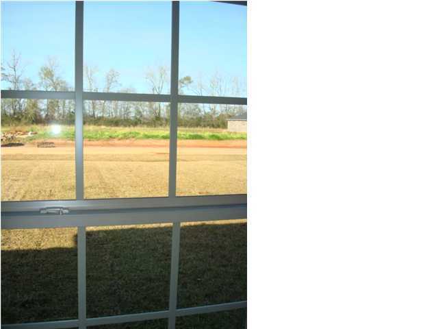 5608 Price Plantation Road Baker, FL 32531 - Photo 16 of 34 a view of a glass door with a big yard