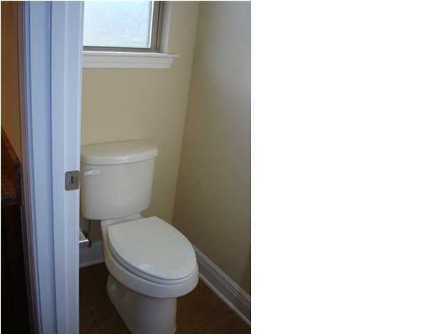 5608 Price Plantation Road Baker, FL 32531 - Photo 27 of 34 a white toilet sitting next to a white cabinet