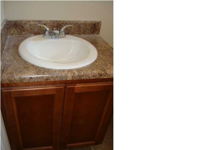 5608 Price Plantation Road Baker, FL 32531 - Photo 30 of 34 a bathroom with a granite countertop sink and a mirror