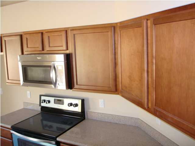 5608 Price Plantation Road Baker, FL 32531 - Photo 7 of 34 a kitchen with stainless steel appliances granite countertop a refrigerator and a stove top oven