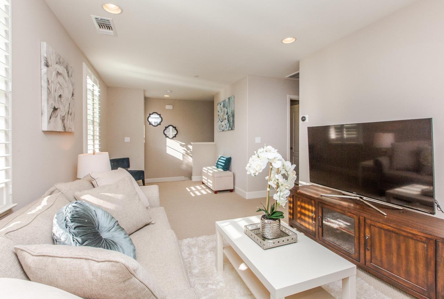 104 Caspian Way Gilroy, CA 95020 - Photo 15 of 33 a living room with furniture and a flat screen tv