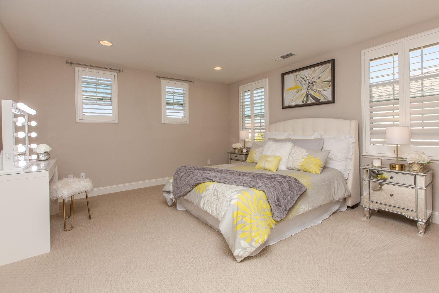 104 Caspian Way Gilroy, CA 95020 - Photo 16 of 33 a spacious bedroom with a bed and a chair