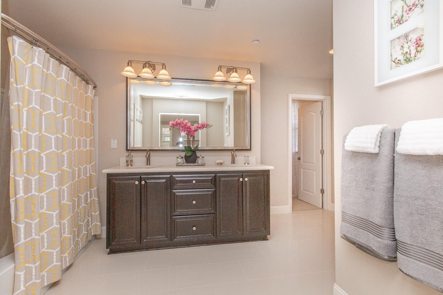 104 Caspian Way Gilroy, CA 95020 - Photo 17 of 33 a bathroom with a sink vanity and a mirror