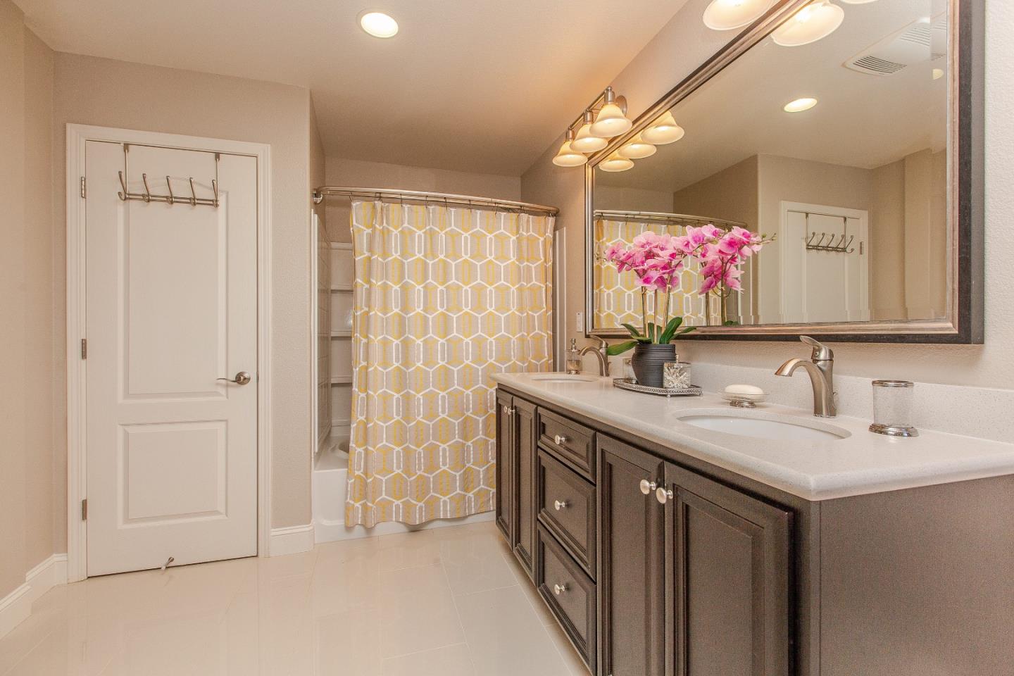 104 Caspian Way Gilroy, CA 95020 - Photo 18 of 33 a bathroom with a sink vanity and a mirror