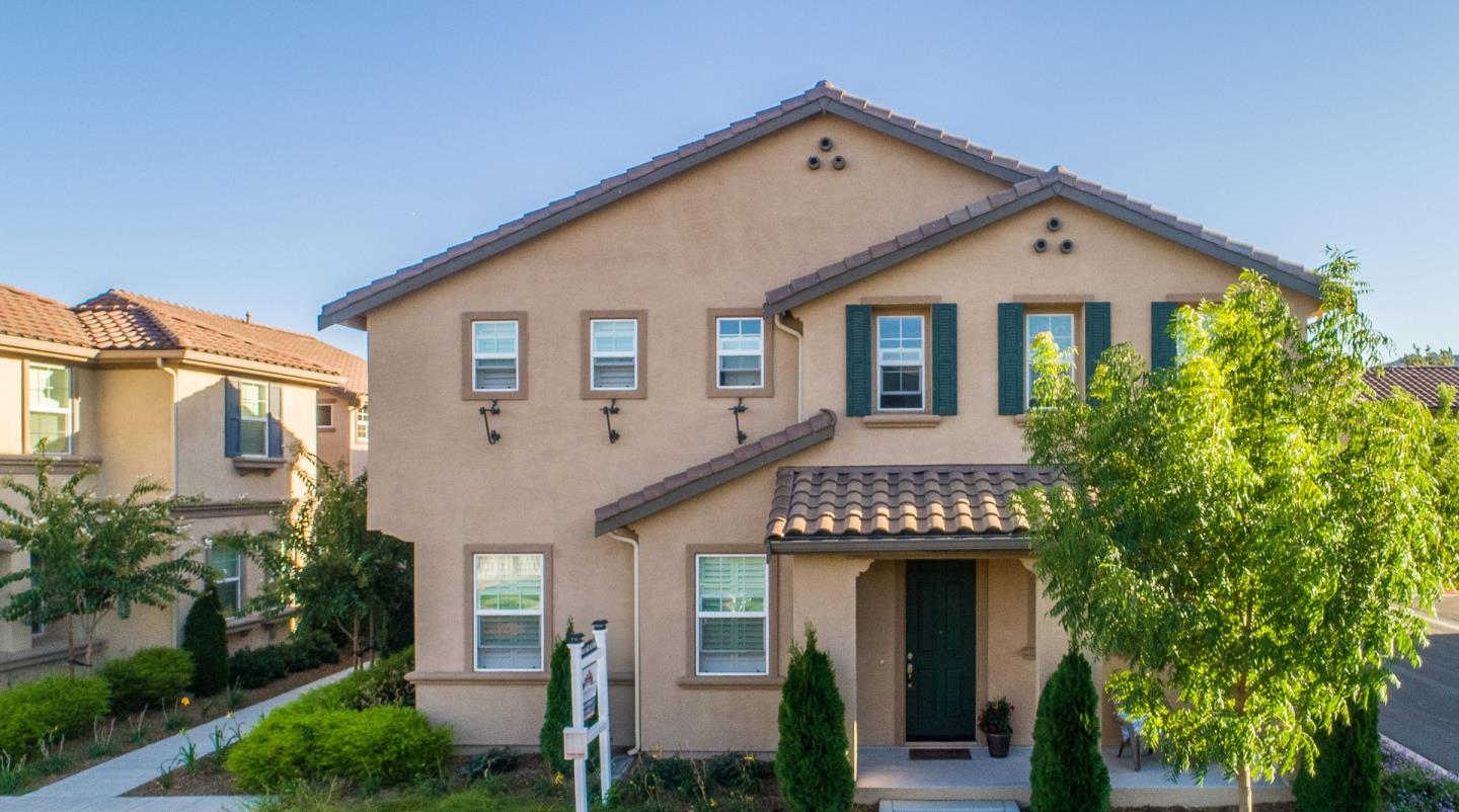 104 Caspian Way Gilroy, CA 95020 - Photo 2 of 33 a front view of a house with a yard and trees