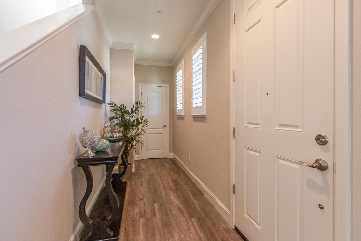 104 Caspian Way Gilroy, CA 95020 - Photo 24 of 33 a view of a hallway with wooden floor and a potted plant