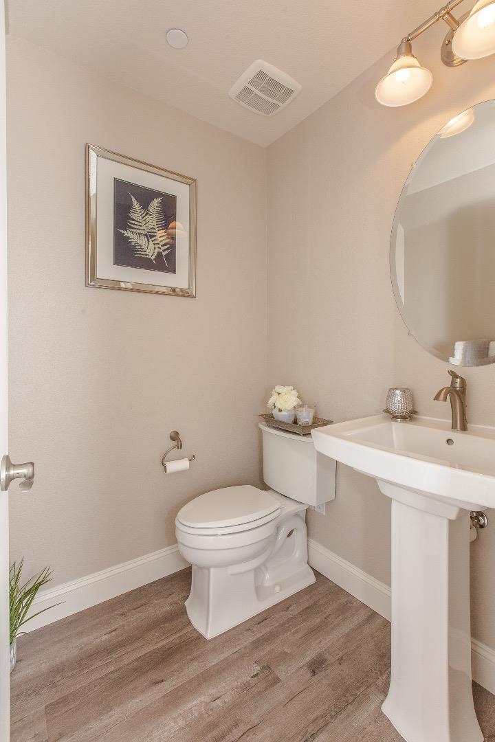 104 Caspian Way Gilroy, CA 95020 - Photo 25 of 33 a bathroom with a toilet a sink and mirror