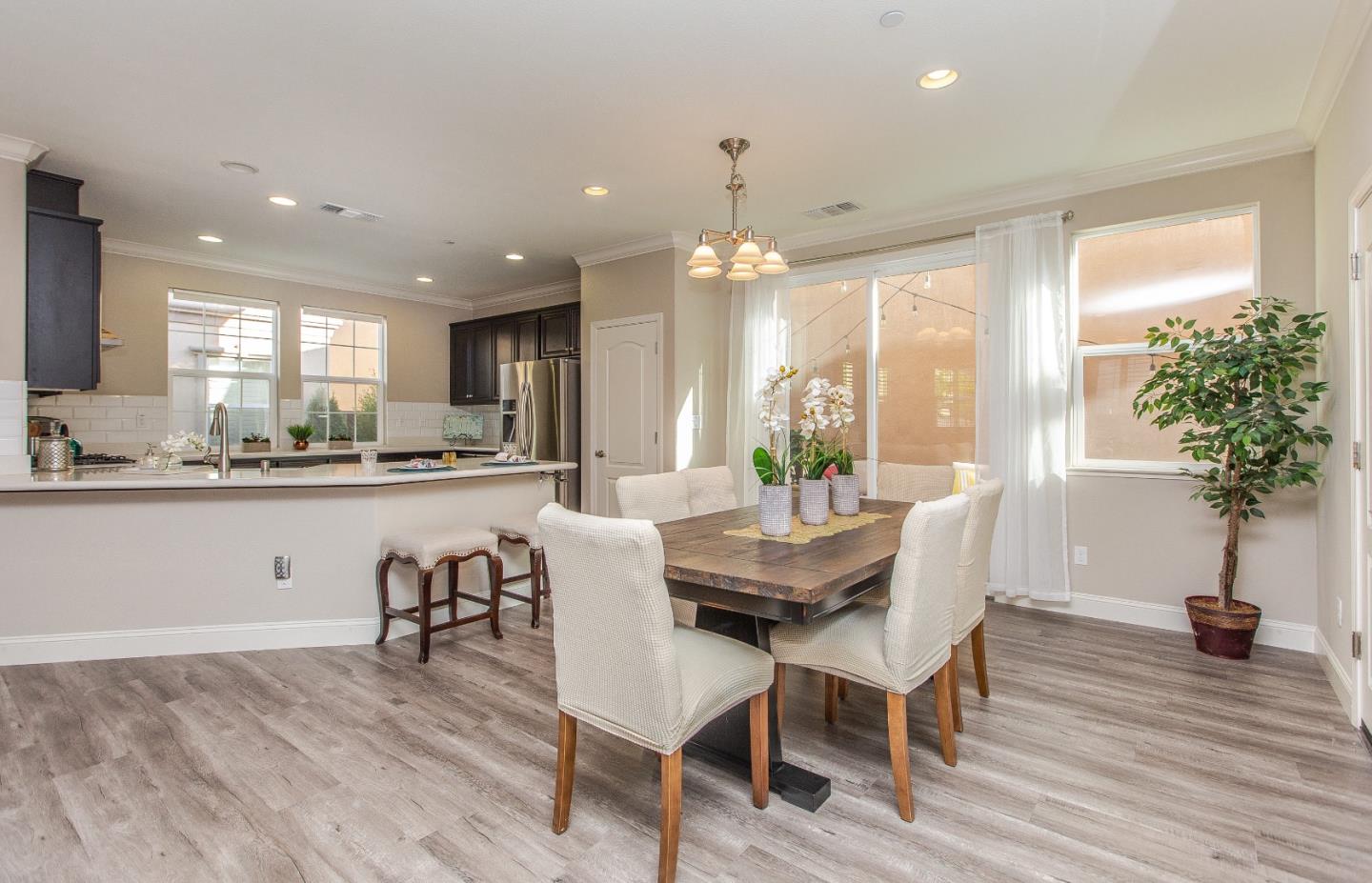 104 Caspian Way Gilroy, CA 95020 - Photo 7 of 33 a dining room with furniture and a floor to ceiling window