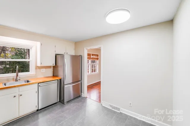 a kitchen with stainless steel appliances a refrigerator and a stove
