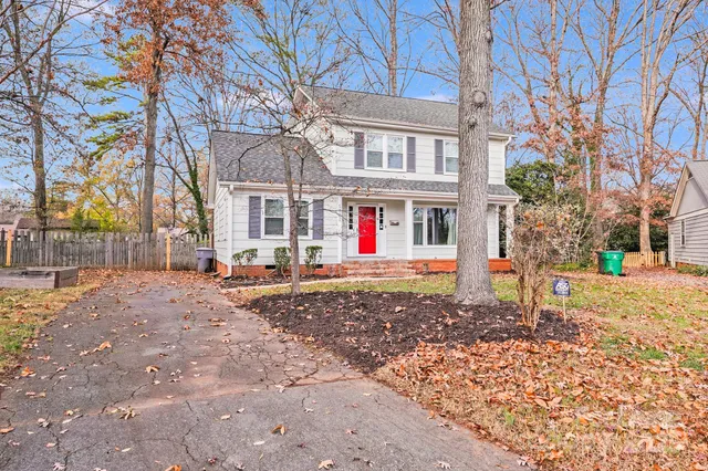 a view of a backyard with large trees