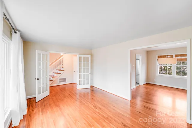 a view of a room with wooden floor and a window