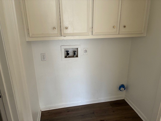 404 West Dittmar Road Austin, TX 78745 - Photo 12 of 15 Laundry area with dark wood finished floors, washer hookup, and cabinet space