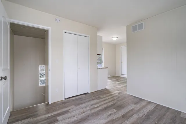 a view of hallway with wooden floor