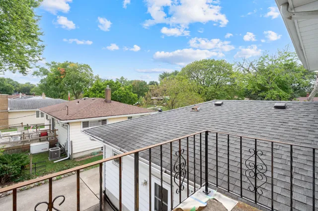 a view of a white house in front of a yard