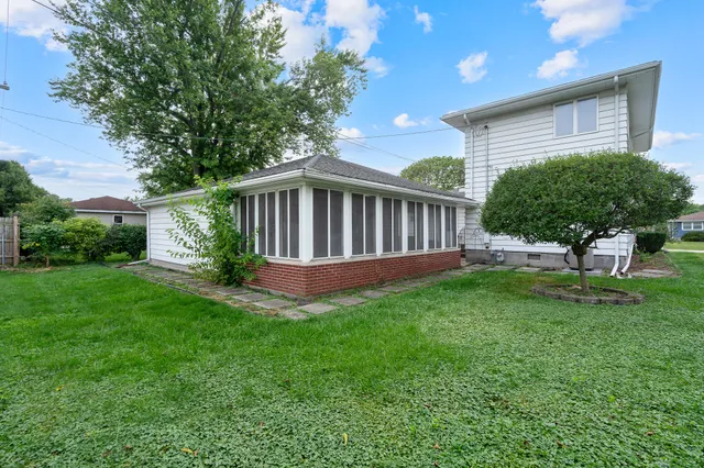 a view of a house with a backyard and porch