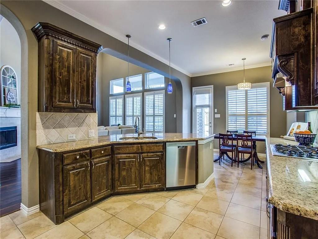 6688 Excelsior Place Frisco, TX 75035 - Photo 13 of 37 a large kitchen with lots of table and chairs