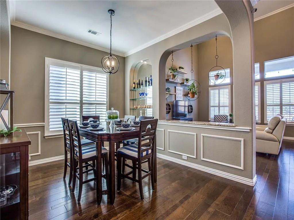 6688 Excelsior Place Frisco, TX 75035 - Photo 18 of 37 a view of a dining room with furniture window and wooden floor
