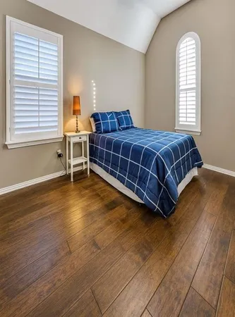 a bedroom with a bed and window