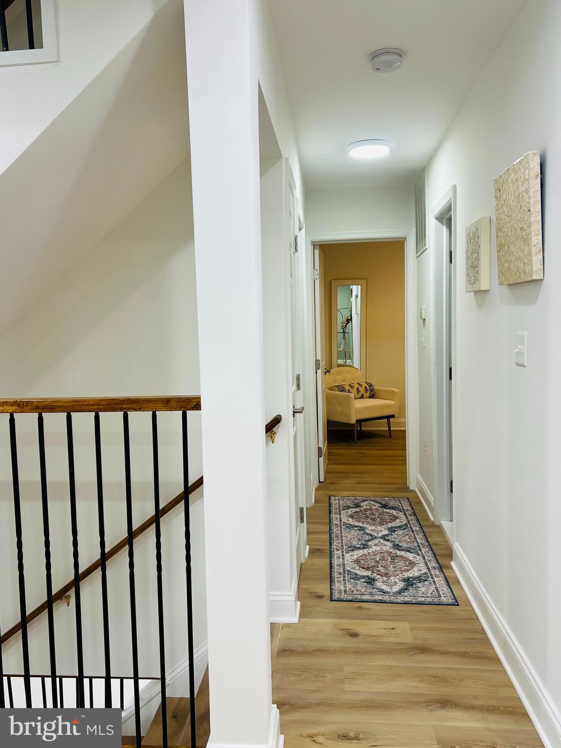 8802 2nd Avenue Silver Spring, MD 20910 - Photo 11 of 60 a view of a hallway with a livingroom and wooden floor a bedroom
