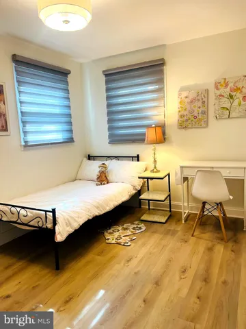 a spacious bedroom with a bed and a table in it