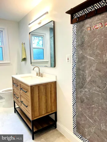 a bathroom with a sink a mirror and a shower