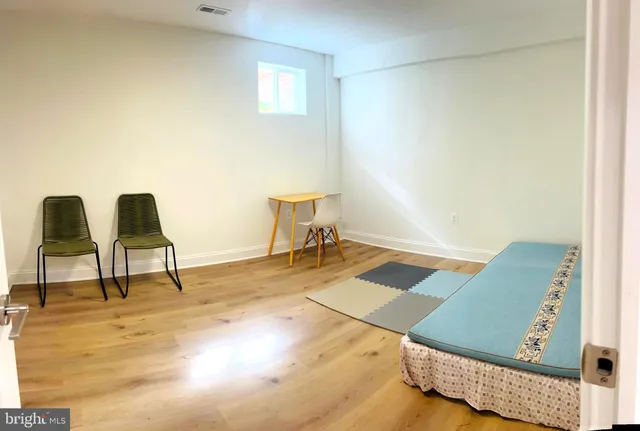 a view of a living room with furniture and wooden floor