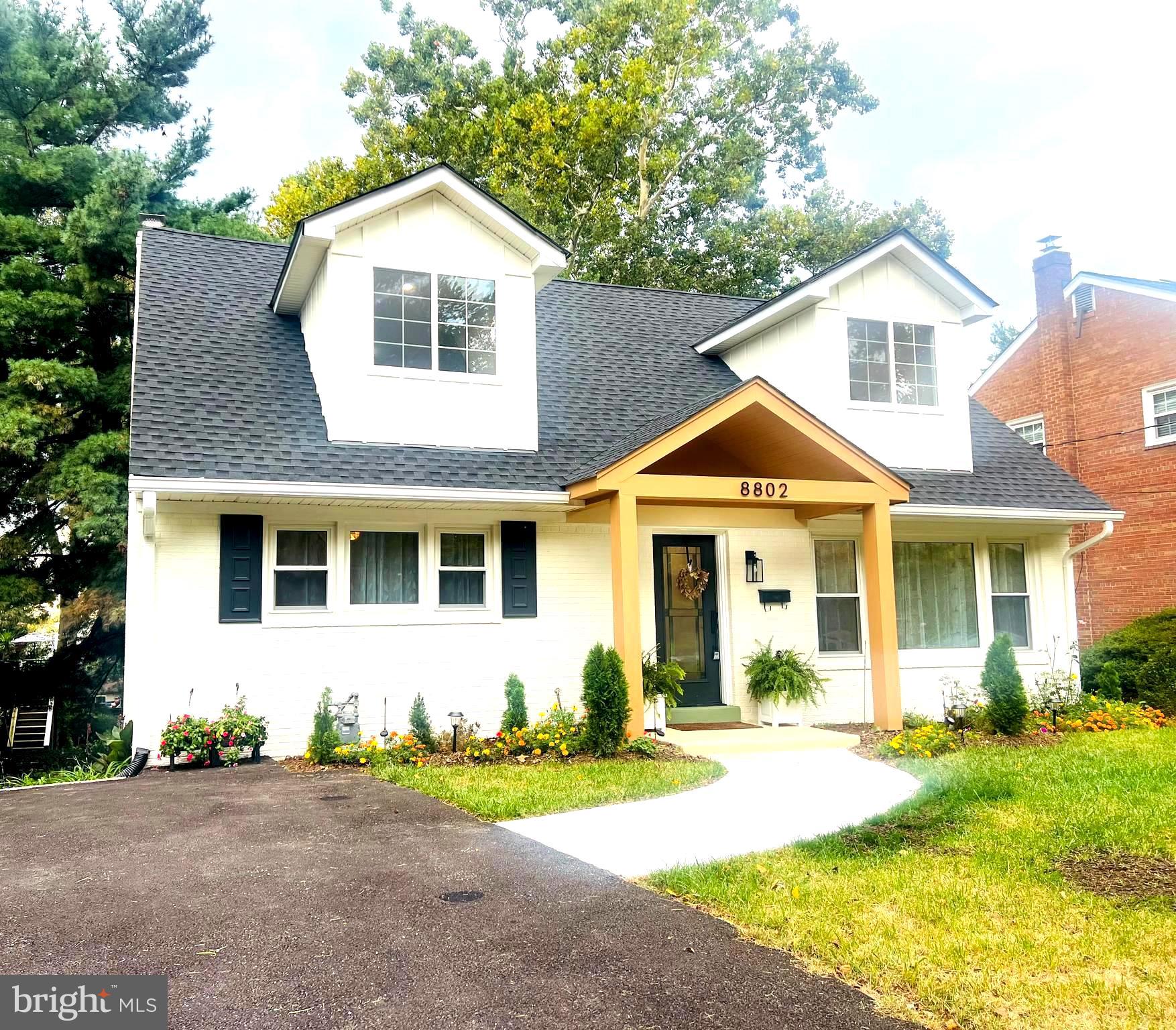 8802 2nd Avenue Silver Spring, MD 20910 - Photo 57 of 60 a front view of a house with a yard and garage