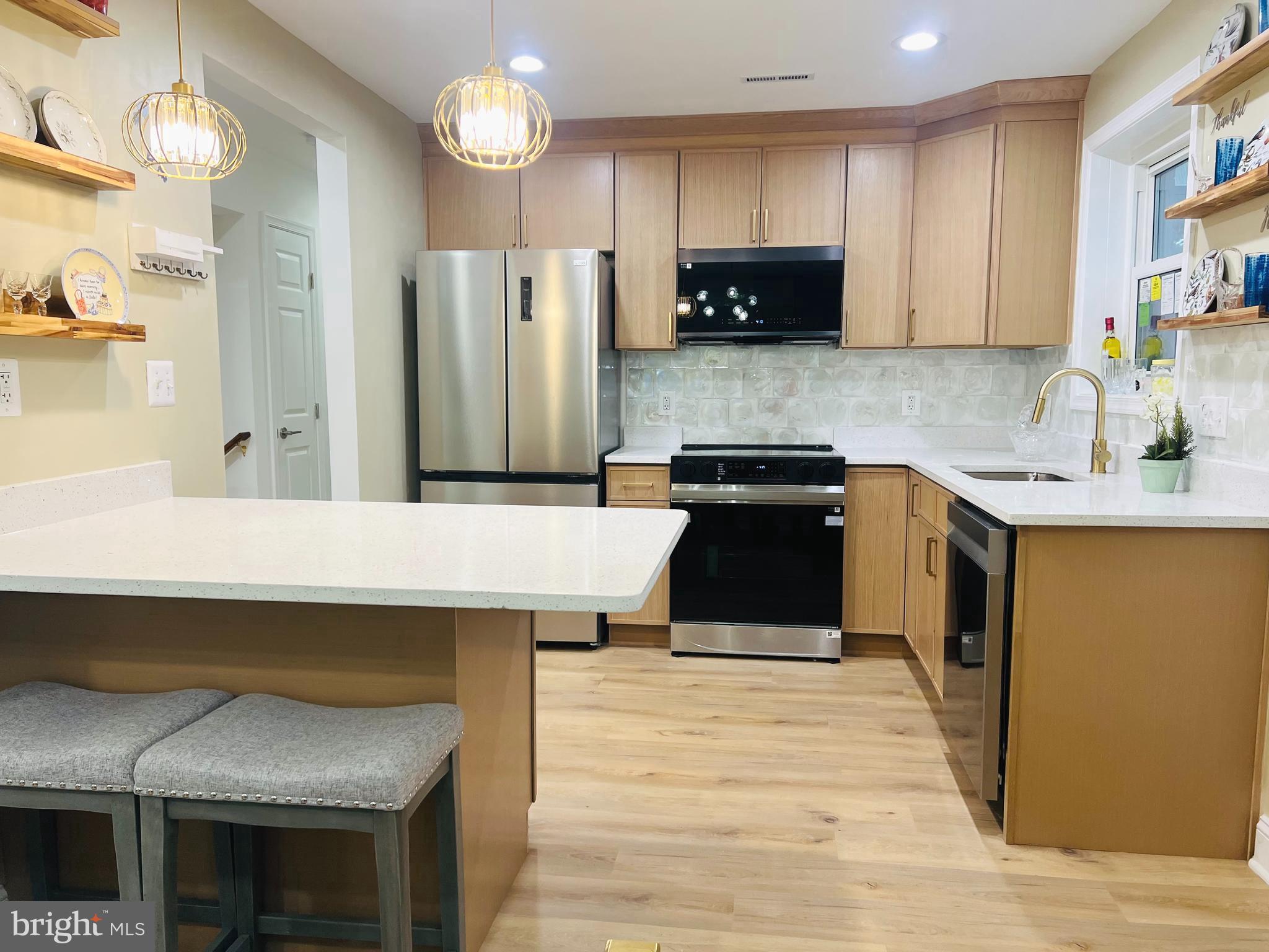 8802 2nd Avenue Silver Spring, MD 20910 - Photo 7 of 60 a kitchen with stainless steel appliances granite countertop a sink stove and refrigerator