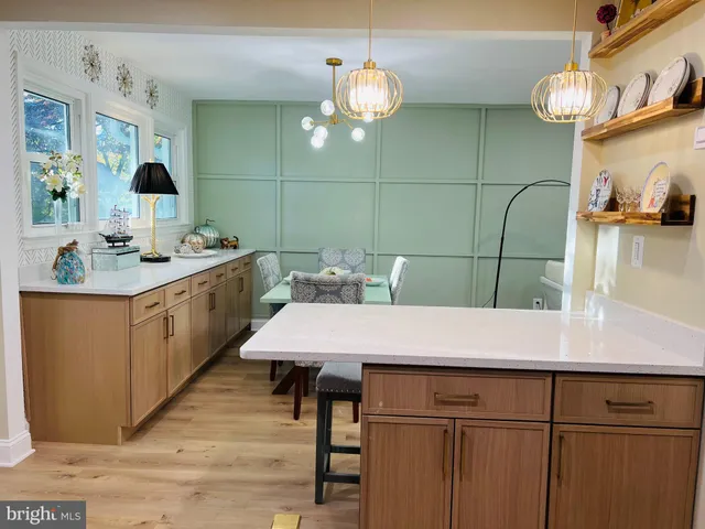 a kitchen with a sink cabinets and wooden floor