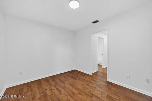 a living room with a white couch and cabinets