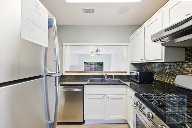 a kitchen with a sink stove and refrigerator