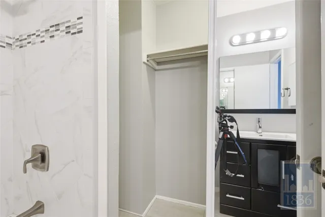 a bathroom with a sink a mirror and a vanity
