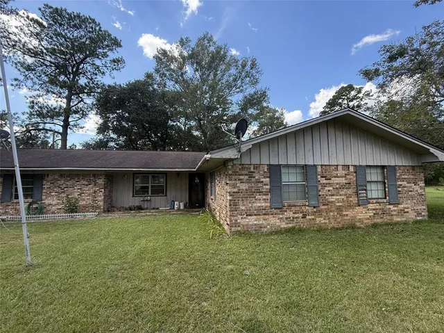 a view of a field with an trees in the background