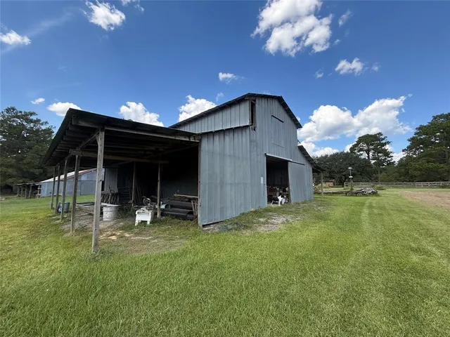 a view of outdoor space with green field and covered with trees