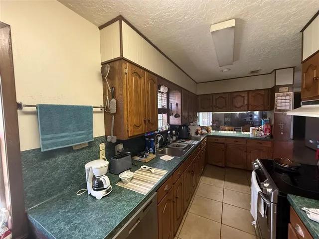 a kitchen with sink and a stove top oven