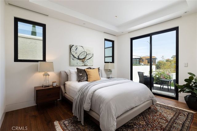a bathroom with a granite countertop toilet sink and mirror