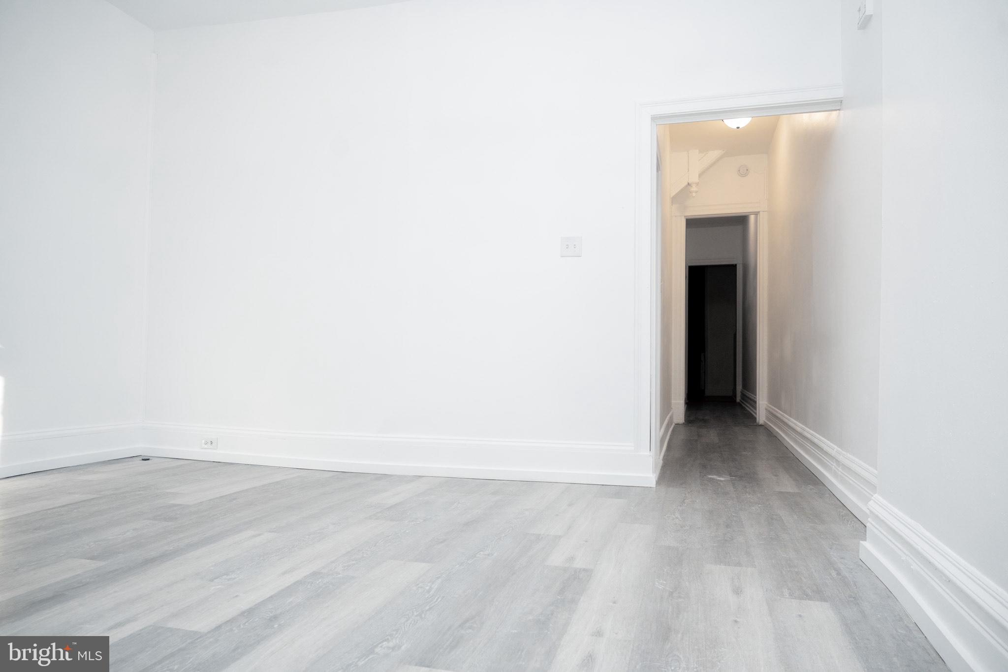 827 North 5th Street, Unit 1 Reading, PA 19601 - Photo 3 of 13 a view of an empty room with wooden floor and a window