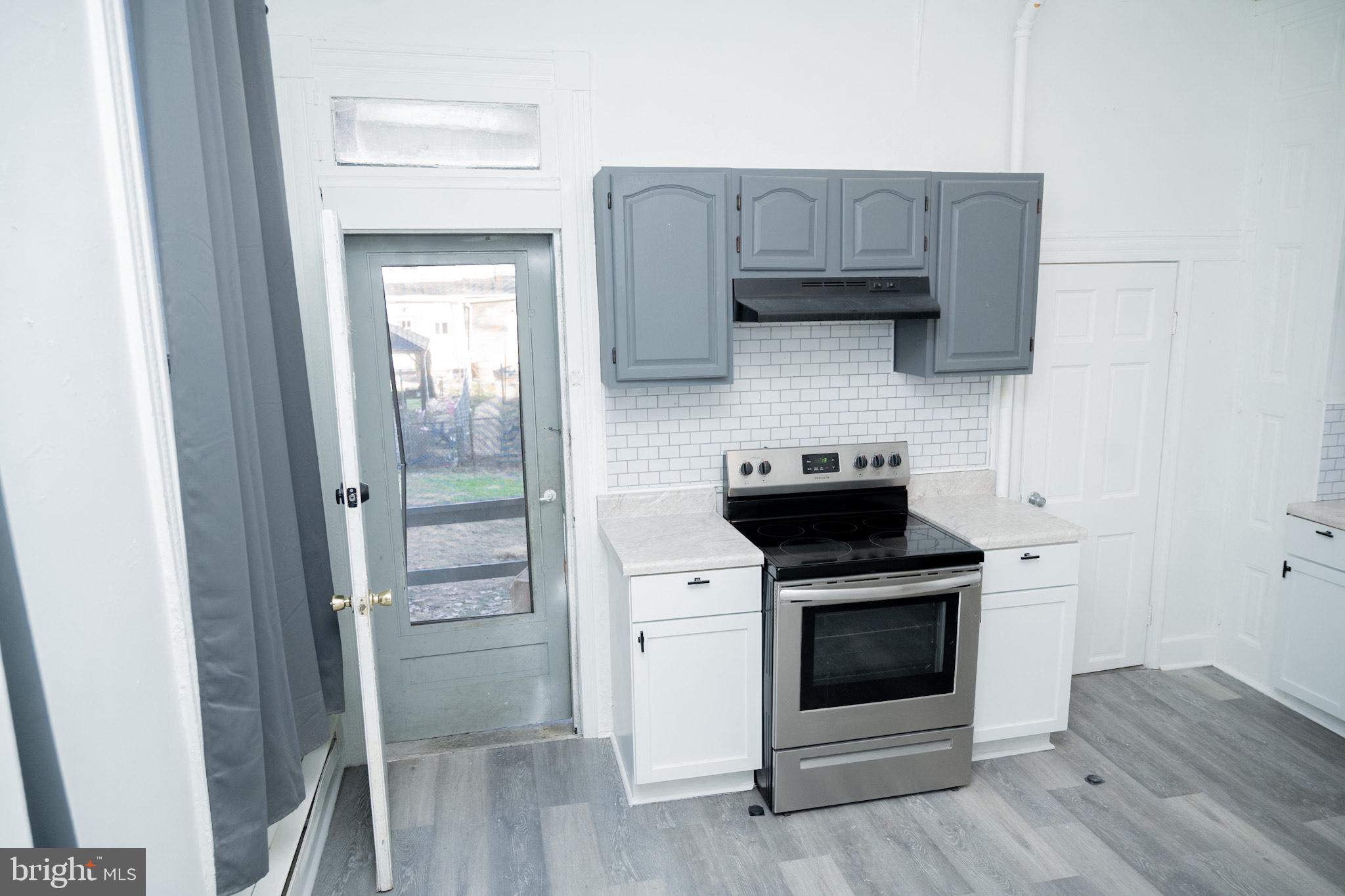 827 North 5th Street, Unit 1 Reading, PA 19601 - Photo 10 of 13 a kitchen with a stove microwave and sink
