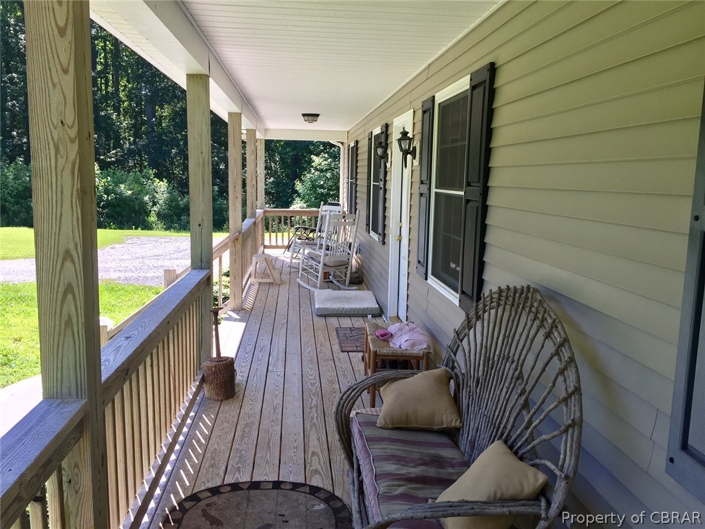 Another view of the front porch and notice a large gravel parking area, would make a great place for a garage