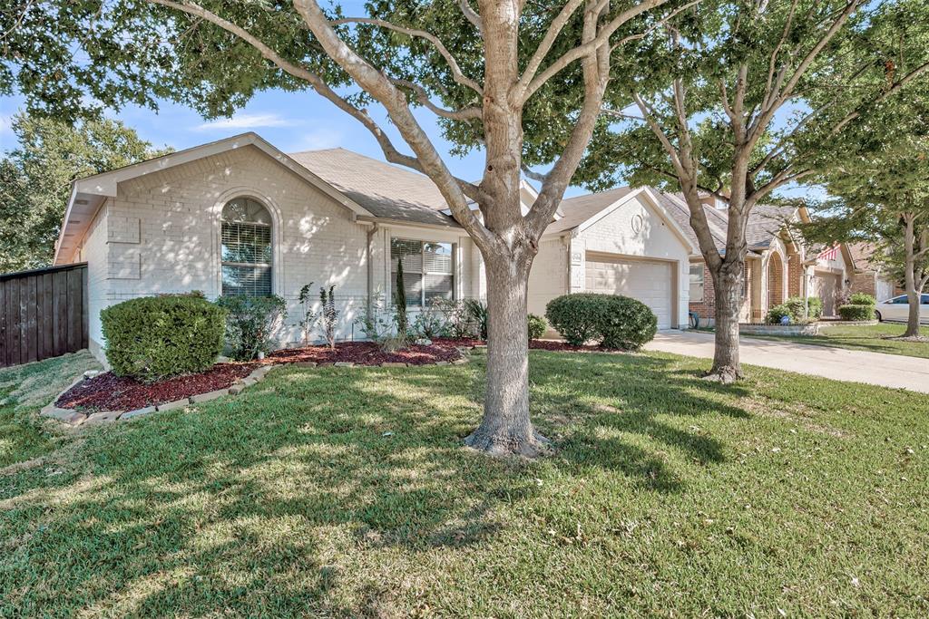 Ranch-style home featuring brick siding, concrete driveway, and an attached garage