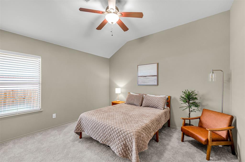12109 Ridge Tree Road Fort Worth, TX 76036 - Photo 17 of 29 Carpeted bedroom with vaulted ceiling and a ceiling fan