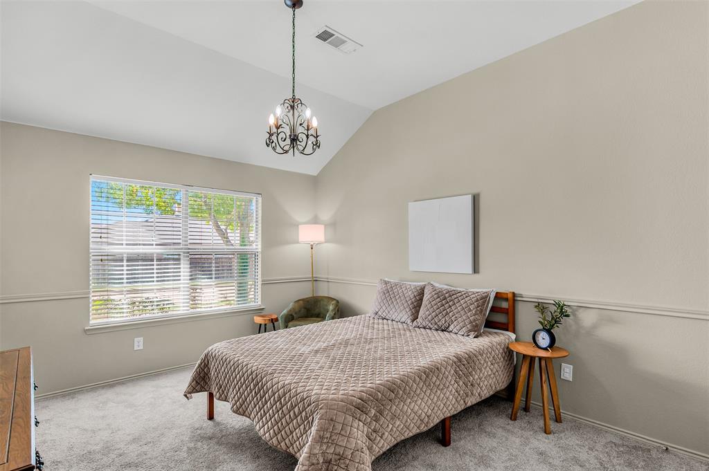 12109 Ridge Tree Road Fort Worth, TX 76036 - Photo 19 of 29 Bedroom with lofted ceiling, carpet floors, and a chandelier