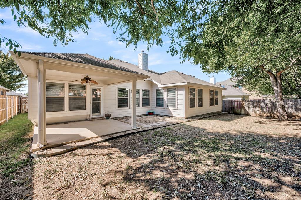12109 Ridge Tree Road Fort Worth, TX 76036 - Photo 27 of 29 Back of house with a patio, a fenced backyard, ceiling fan, and a chimney